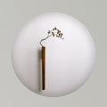 A minimalist wood wall vase styled against a large white circular background.
