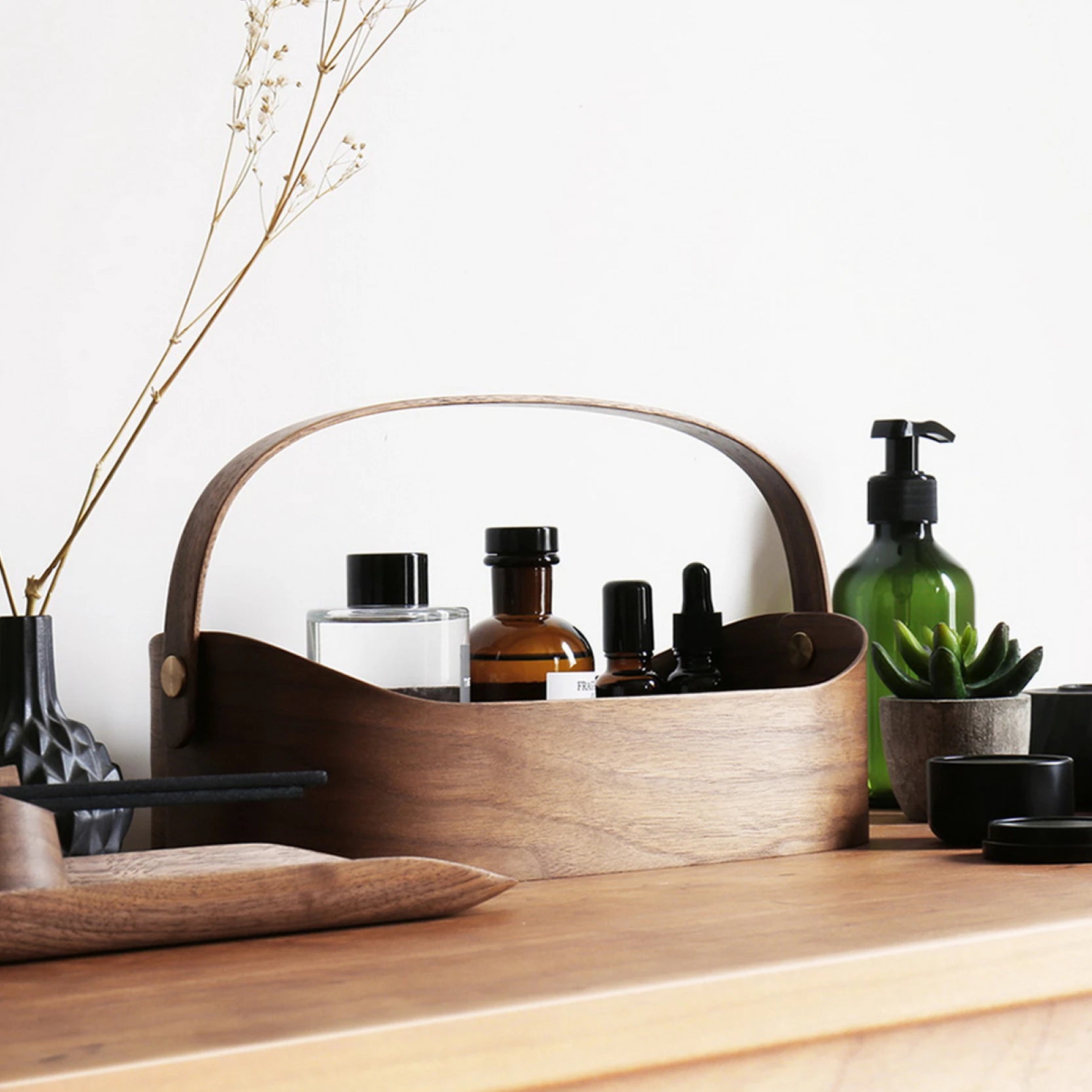 A dark walnut bentwood organizer caddy on a modern wood console.