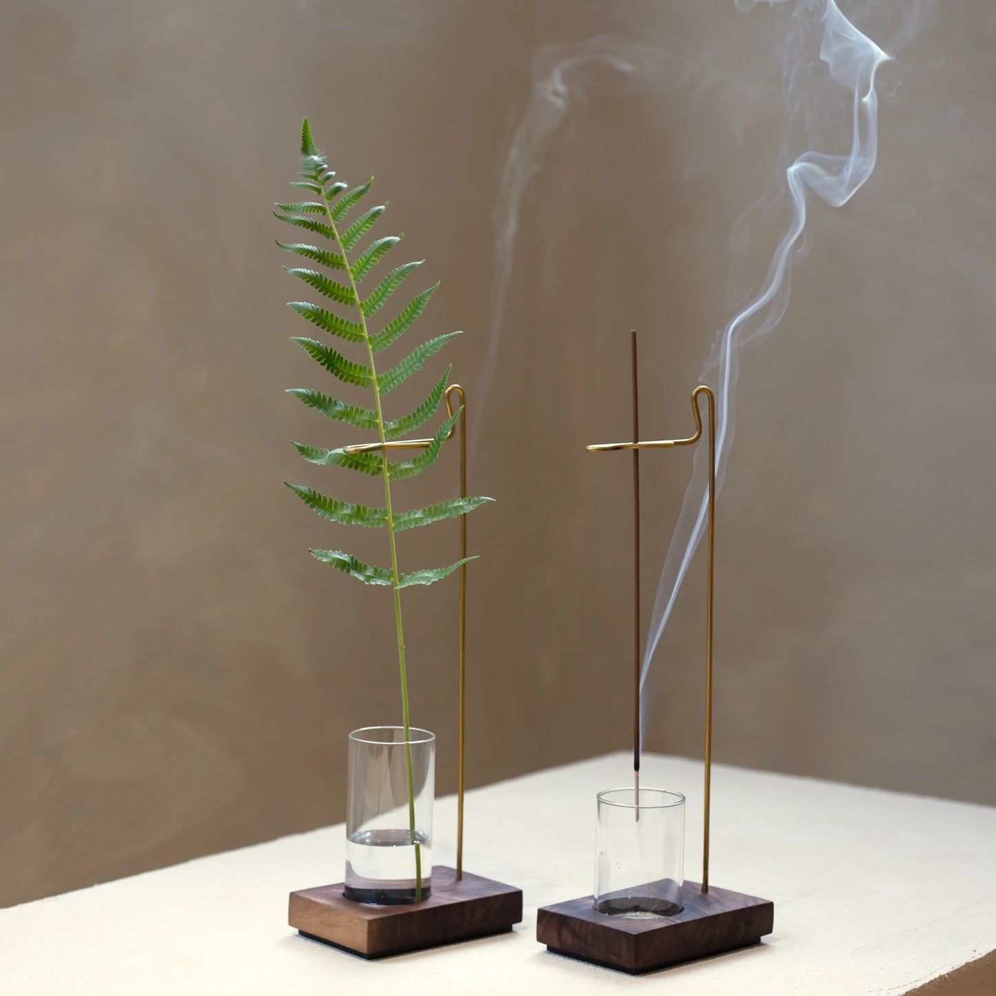 Two suspension holders: one as a vase, one burning stick incense.