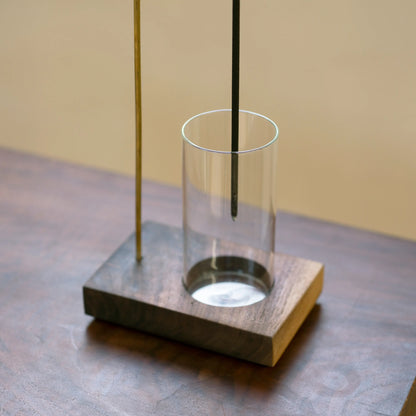 Close-up of the glass ash catcher in the walnut base of the holder.