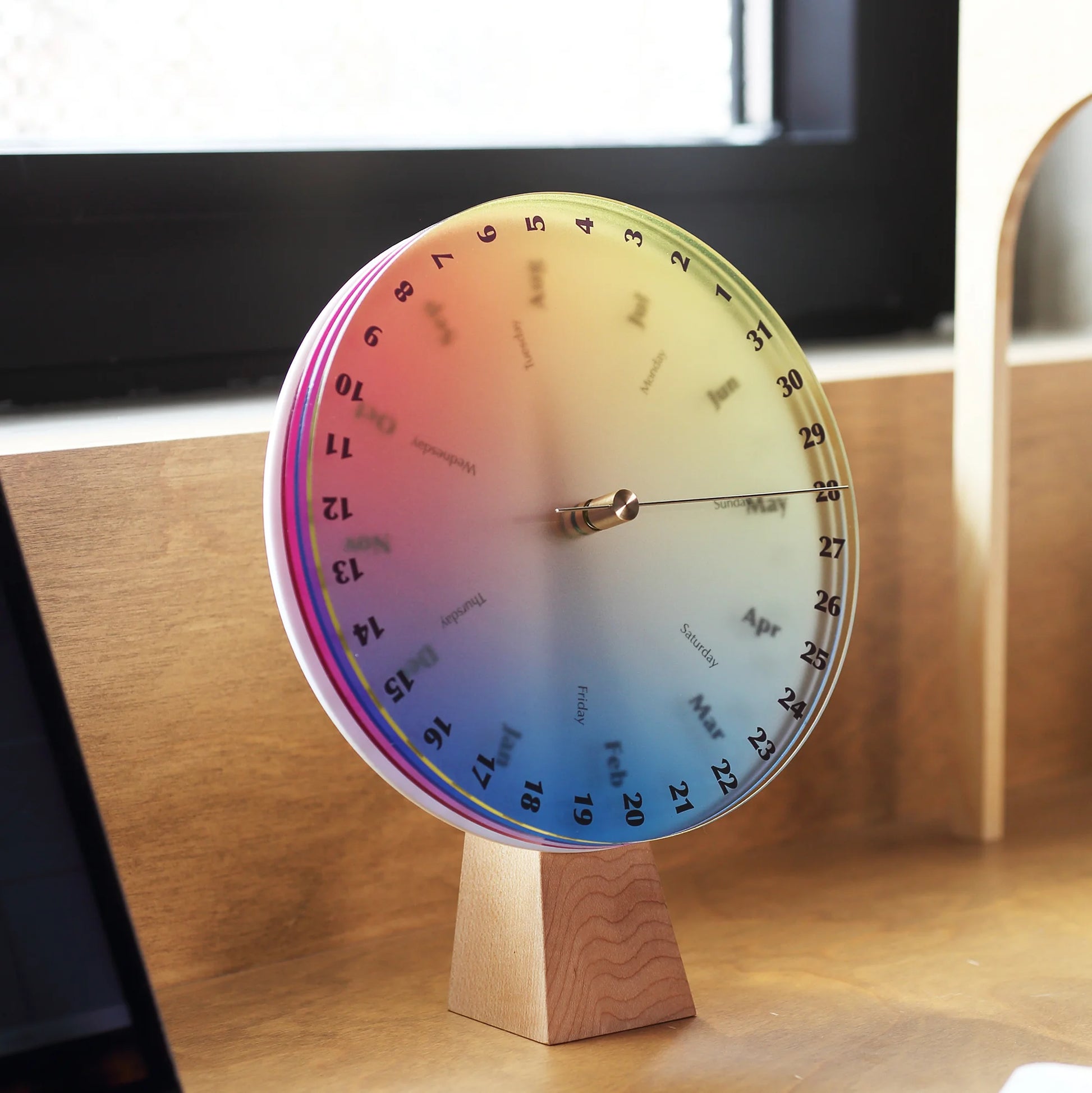 Angled side view of the layered acrylic discs on the color calendar.