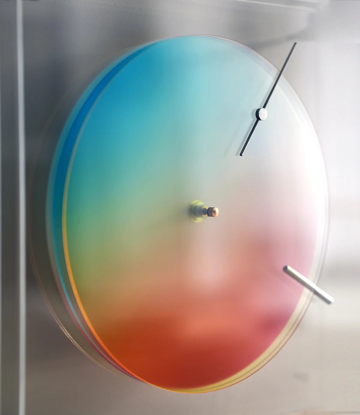 Close-up of the rainbow color wheel disc of the kinetic art clock.
