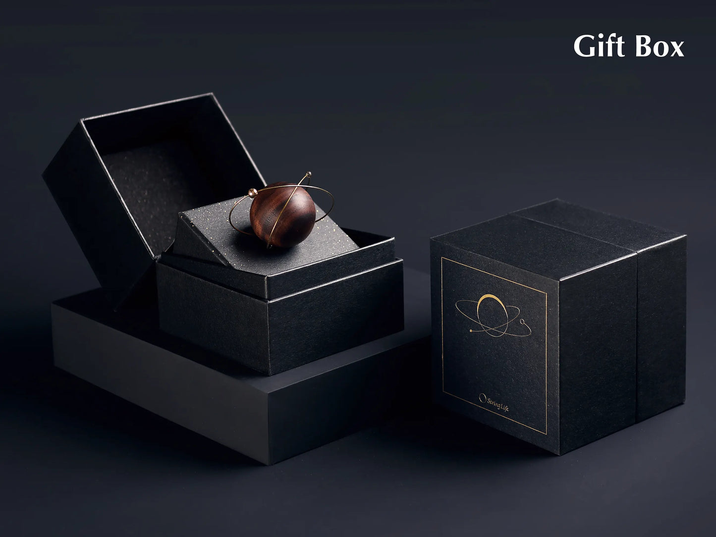 A luxury car scent diffuser in a black gift box with gold lettering.
