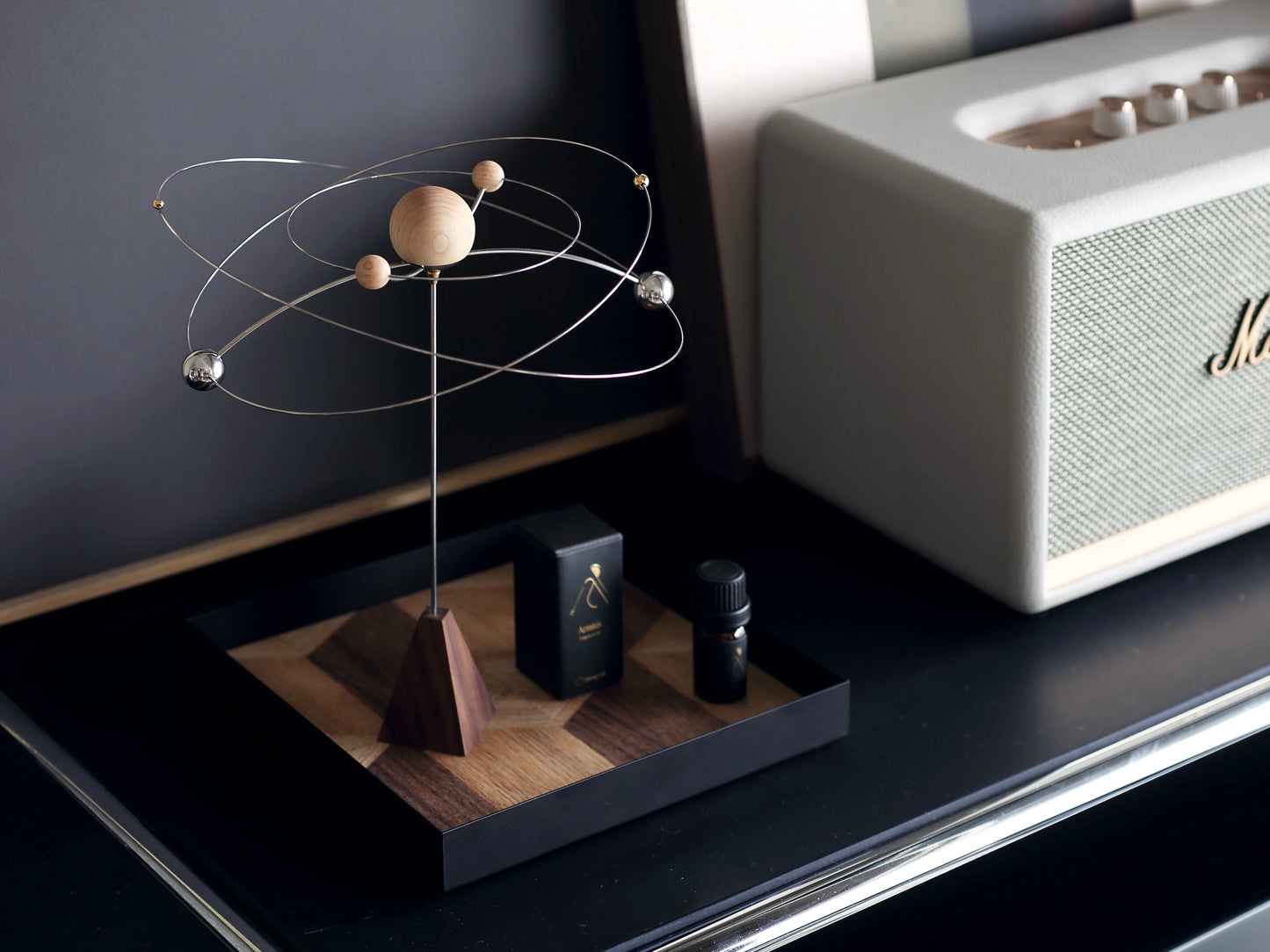 The galaxy diffuser on a black tray next to a Marshall speaker.