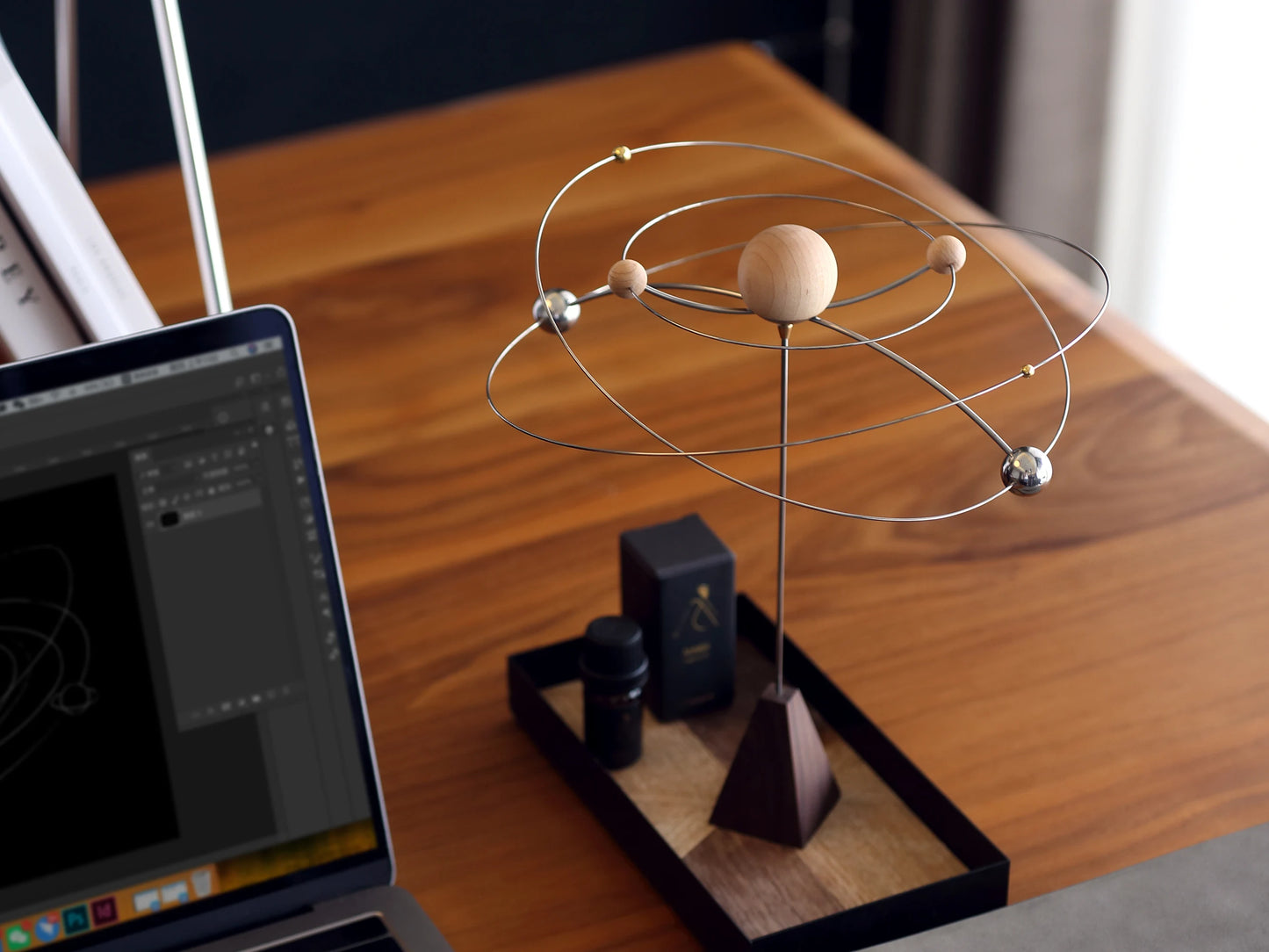 The maple wood version of the kinetic diffuser on a modern desk.