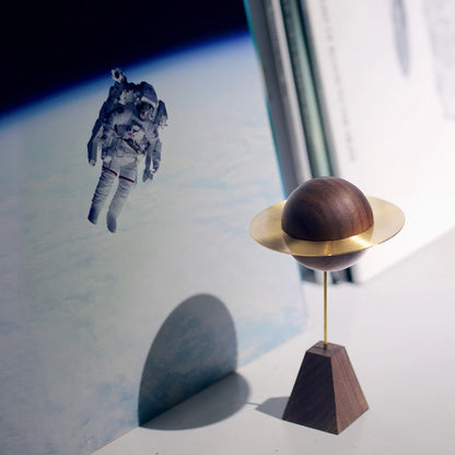 Planet diffuser next to an art print of an astronaut in space.