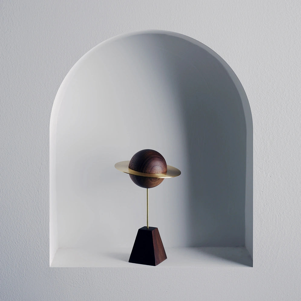 A small planet diffuser styled inside a white arched wall niche.