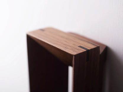 Close-up of the mortise and tenon joint on the solid walnut wall light.