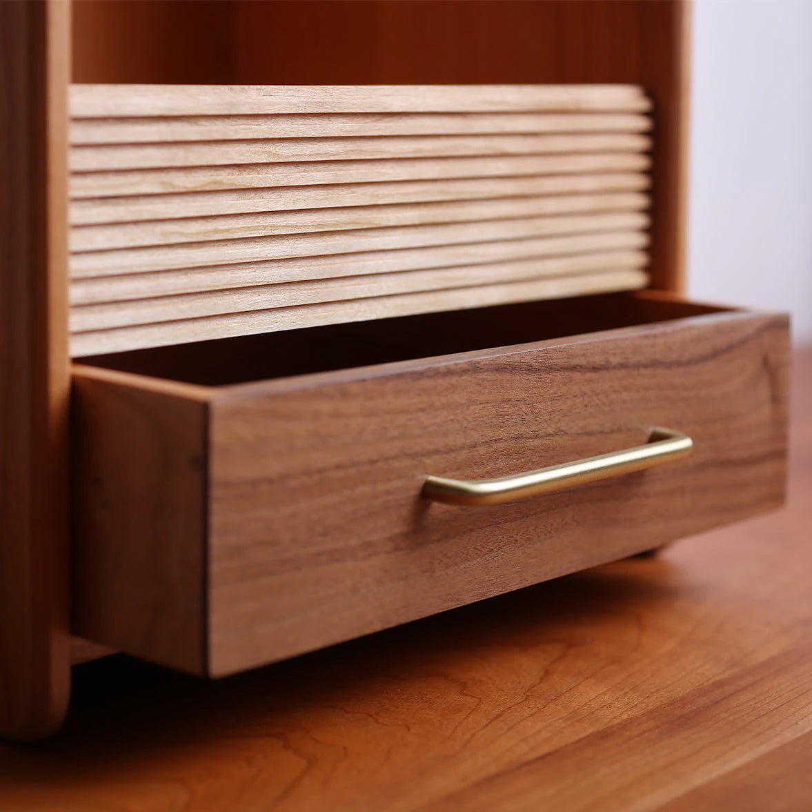 Close-up of reeded wood and walnut drawer on a vanity organizer.