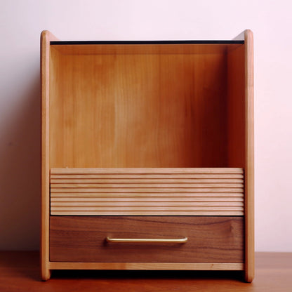 Front view of reeded wood makeup organizer with glass top shelf.