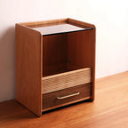 Angled view of wood and glass vanity organizer on a wood floor.