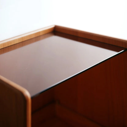 Close-up of the tempered glass top on a cherry wood vanity box.