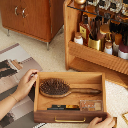 Woman holding removable drawer of wood organizer with makeup inside.