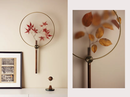 A Japandi wall vase with red maple leaves, styled as a modern fan.