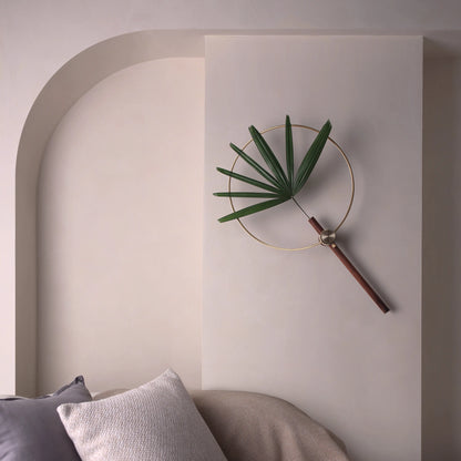An adjustable wall vase with a fan palm, styled next to an arched wall.