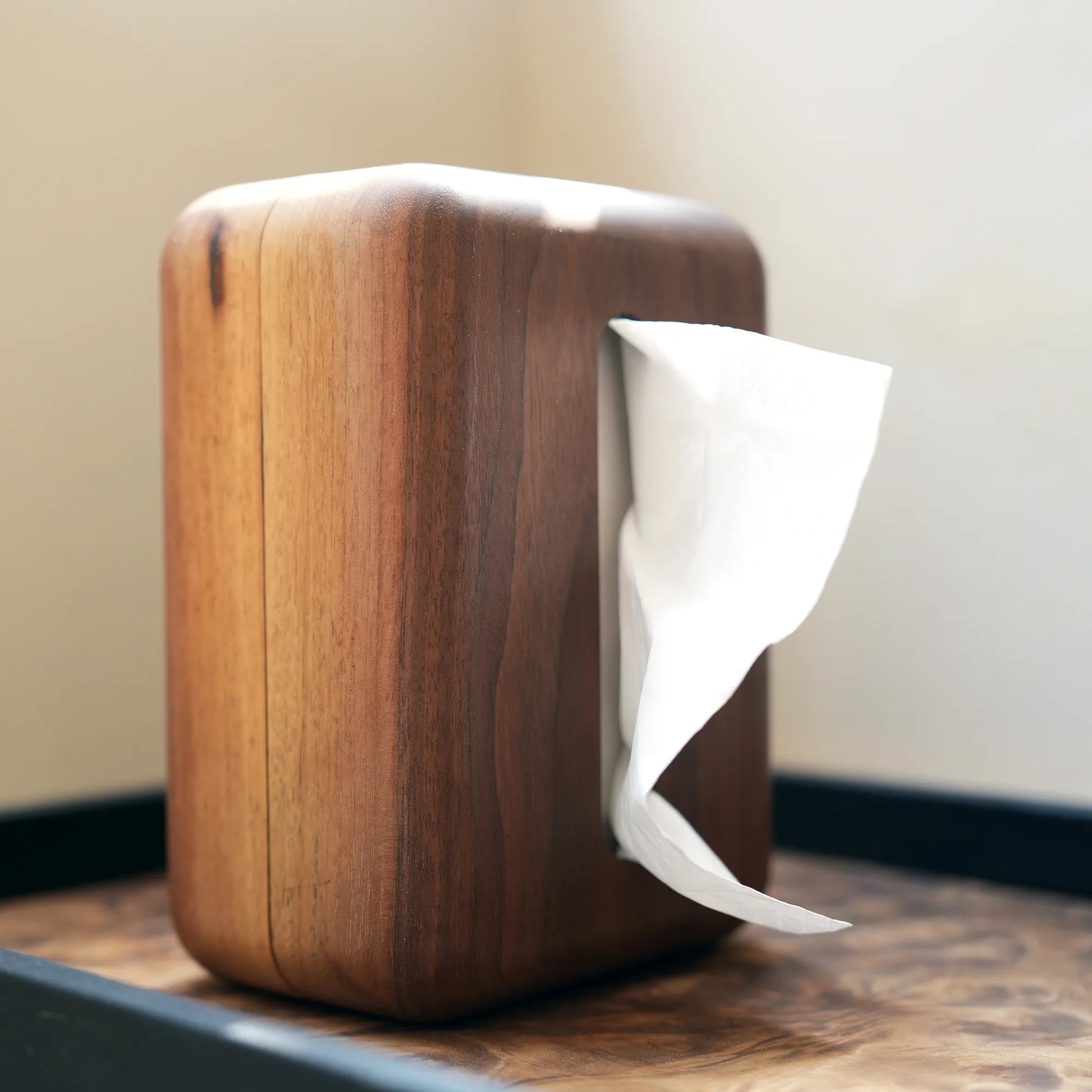 A walnut tissue box cover standing vertically to fit a narrow space.