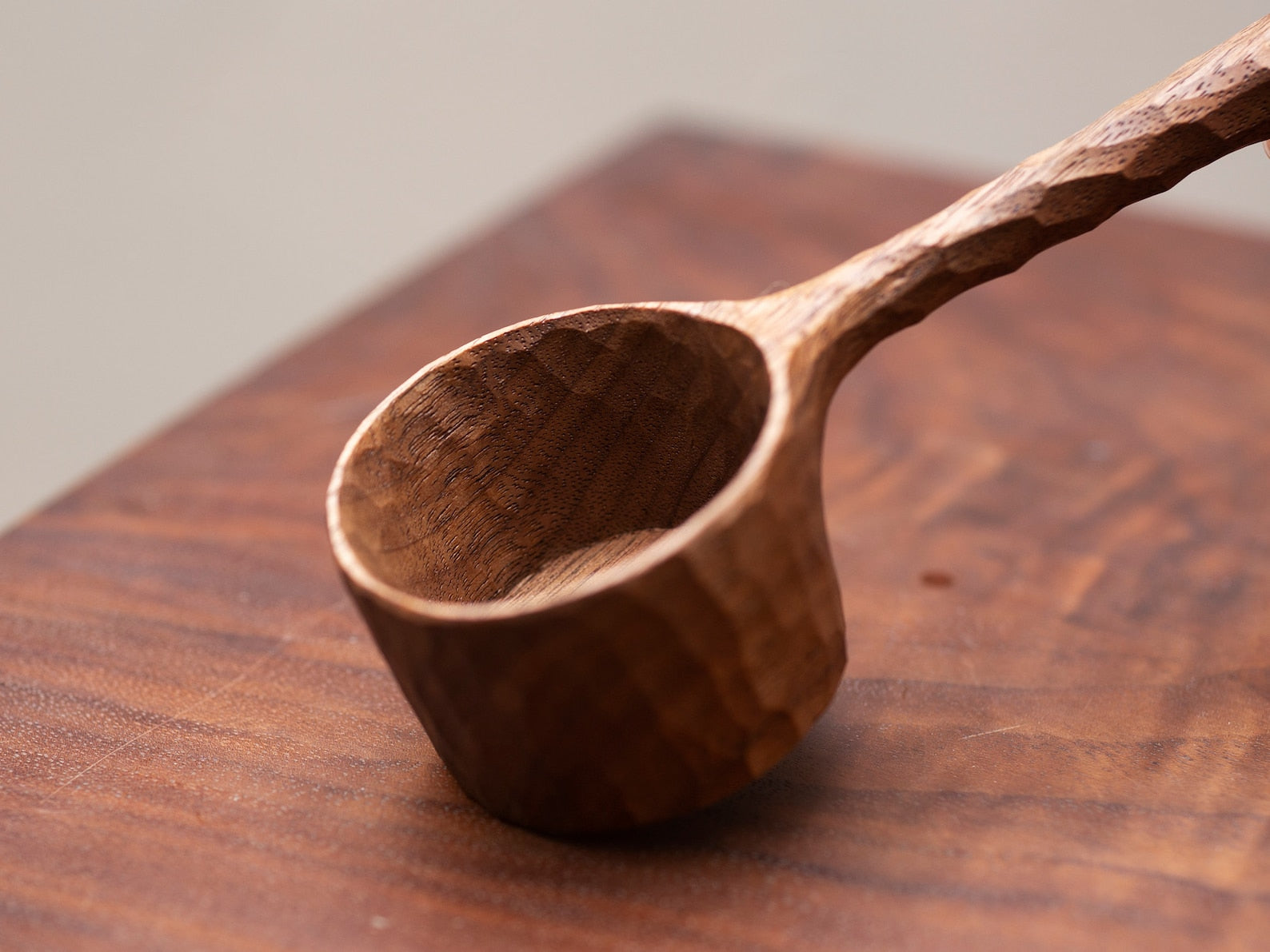 Close-up of the hand-carved bowl of the wabi-sabi style coffee scoop.