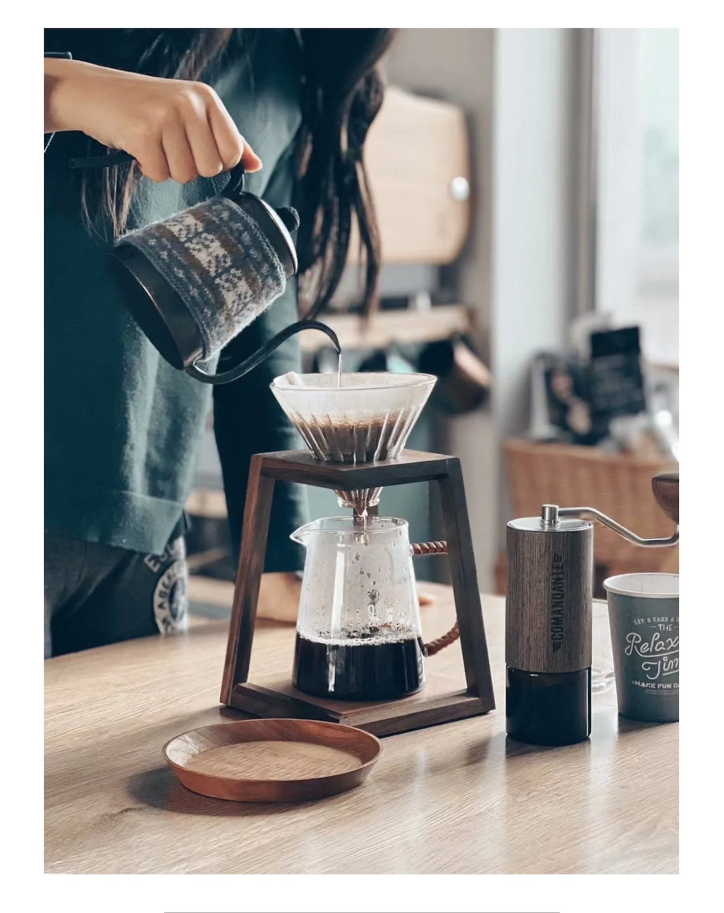 A complete coffee station with a walnut dripper stand and a coffee grinder.