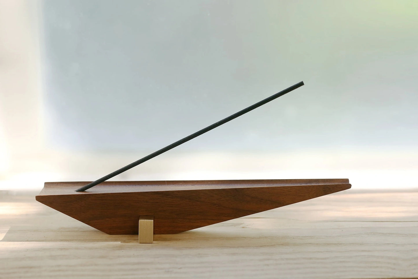 Side view of the minimalist, faceted design of the walnut incense holder.