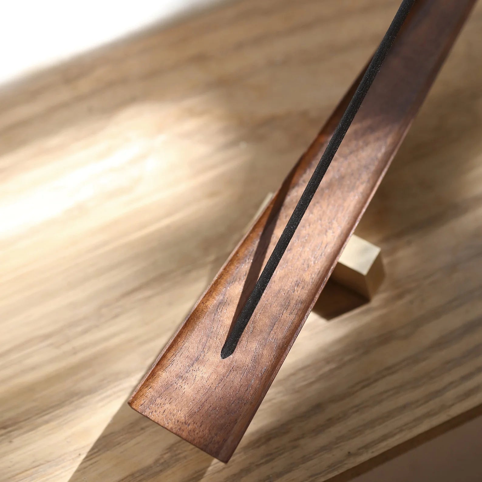 Overhead view of the carved trough in the walnut incense ash catcher.