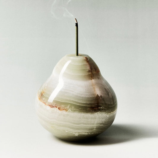 A hand-carved onyx pear incense holder with green and brown banding.