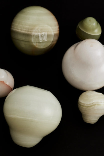 Collection of onyx pear incense holders on a black background