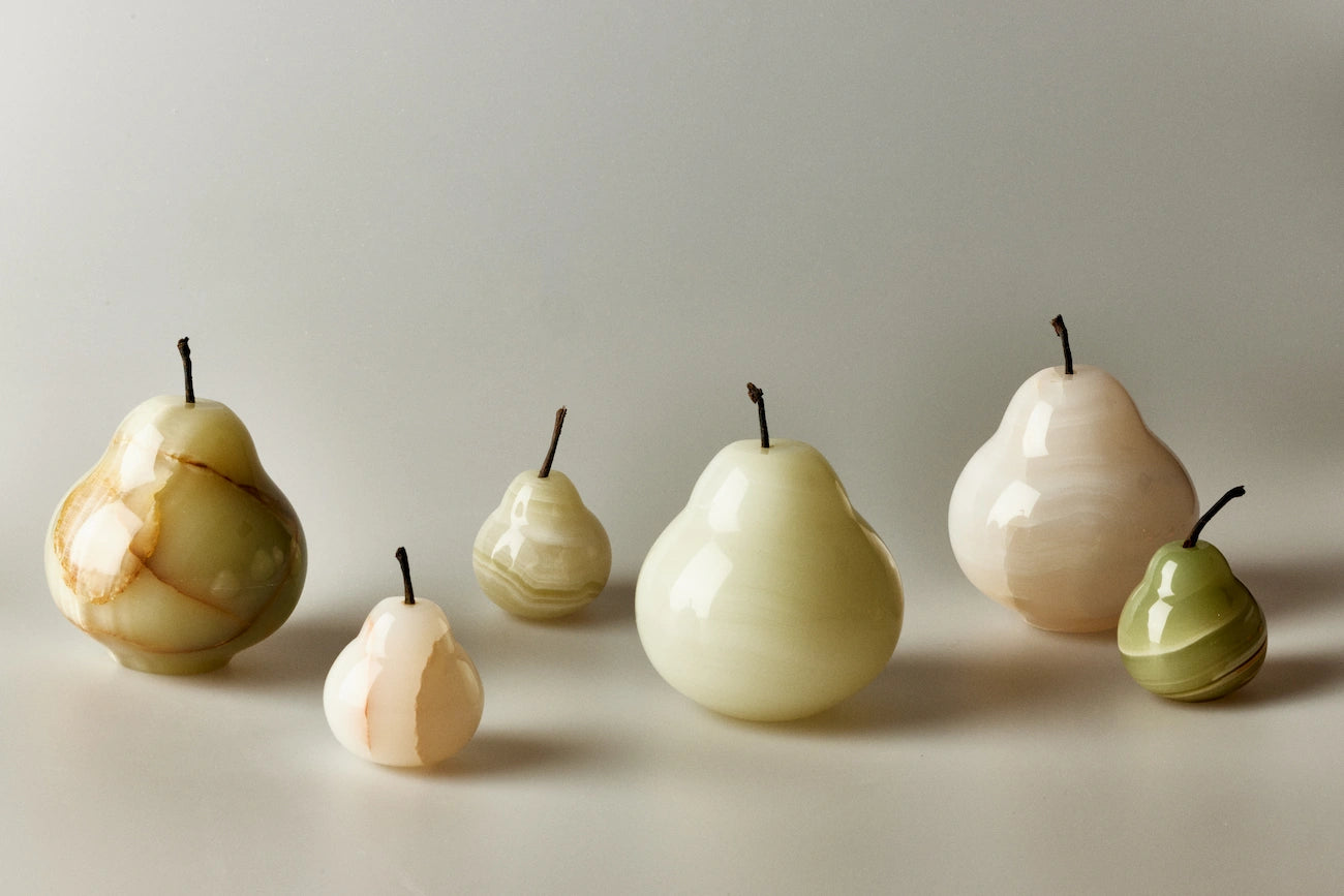 Set of marbleized pear-shaped onyx incense holders on a neutral background