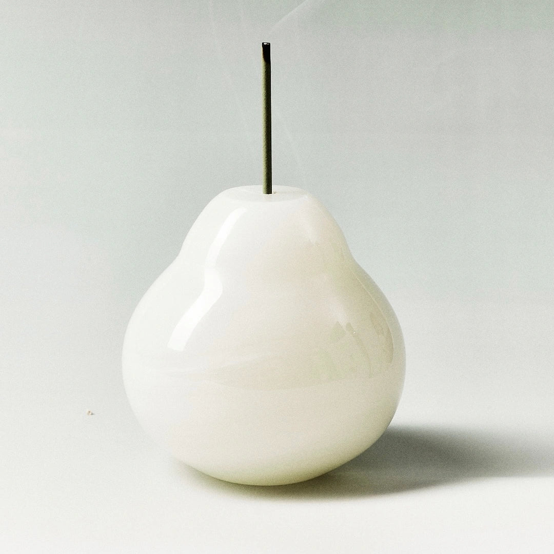 A simple, highly polished white onyx pear incense holder.