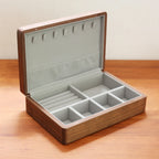 Open walnut wood jewelry box with a soft grey flannel interior.