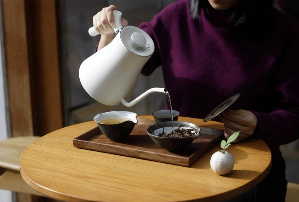 Walnut tea tray with tea bowls, person pouring hot water, ceremony
